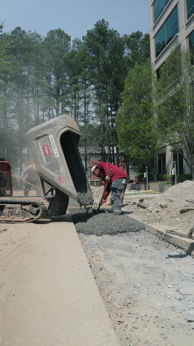 008 Concrete placing fresh concrete from a Toro buggy on a commercial flatwork pour in Marietta Georgia