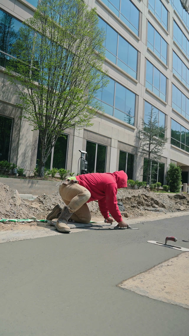 008 Concrete crew hand-finishing a fresh commercial flatwork pour at a Marietta Georgia office park
