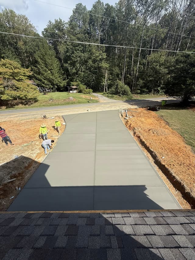 Finished broom-textured concrete slab with sharp expansion joints poured by 008 Concrete crew on a Cobb County Georgia commercial site