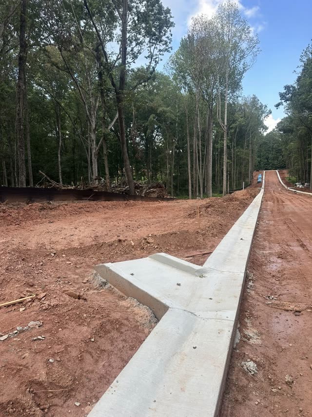 Freshly-poured concrete curb and sidewalk running through a Cobb County Georgia commercial site by 008 Concrete